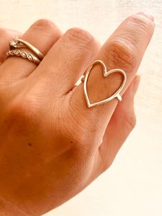 This Sterling Silver Hammered Heart Ring is perfect for any occasion - from casual everyday style to a romantic statement that feels as sweet as young love. PRODUCT DETAILS limited edition, Sizes: 7-10 This listing is for ONE (1) hammered open-heart ring. Material: Crafted from high-quality 925 Sterling Silver. ＊Please note that our rings are carefully handcrafted and hammered, which means that each finished product may have slight variations. Trendy Heart-shaped Promise Rings, Simple Heart Midi Rings, Everyday Open Heart Rings With Heart Charm, Trendy Open Heart Ring For Valentine's Day, Simple Everyday Heart Midi Rings, Valentine's Day Elegant Midi Rings, Trendy Heart-shaped Open Promise Ring, Trendy Heart-shaped Rings For Valentine's Day, Trendy Silver Heart Ring For Valentine's Day