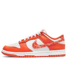 The Nike Dunk Low 'Orange Paisley' is a stylish and iconic sneaker for women. It features a white leather base with an orange upper, brand tongue, insole, and rubber sole. The Swoosh and heel are accented with a paisley bandana print, while the tongue, heel, insole, and midsole remain white. This sneaker is perfect for everyday wear, whether you're running errands or going out with friends. The inspiration for this design comes from the classic Dunk series, which has been a staple in Nike's lineup since the early 2000s. (SNKR/Skate/Low Top/Women's) 720 Nike, Dunk Shoes, Nike Air Max Excee, Jordan 8, Nike Sb Dunks Low, Nike Sb Dunk, Cute Nikes, Nike Sb Dunks, Sb Dunk