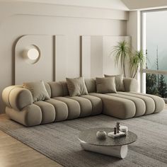 a living room with a large sectional couch and coffee table in front of a window