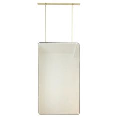 a white rectangular light hanging from a metal rod