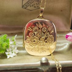 *Note* This locket is a full 9ct gold locket with a 9ct gold chain*  The difference between 9ct gold lockets and 9ct gold front and back lockets is: Full gold content: A "9ct gold locket" is entirely made of 9ct gold.  Partial gold content: A "9ct gold front and back locket" means only the front and back parts are 9ct gold, with other components being a different metal that has been gold plated. A stunning vintage 1992 9ct yellow gold large cushion shaped hinged locket with exquisite floral spra Antique Gold Locket Necklace Stamped 14k, Vintage 14k Gold Locket Necklace Stamped 14k, Vintage 14k Gold Locket Necklace, Victorian Gold Necklaces With Hallmark, Rose Gold Hallmarked Locket Necklace Gift, Antique Gold Necklaces For Keepsake, Vintage Gold Locket Necklace Stamped 14k, Classic Gold Hallmarked Locket Necklace, Antique Gold Hallmarked Locket Necklace