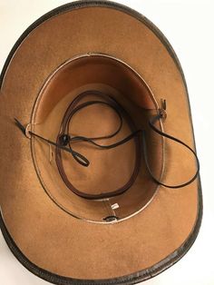 Item Description Designer Series Hat. 100 % genuine cowhide leather outback hat, durable and great executive style. This designer Hat is Only For High Class executive people. sizes are available from Medium to X Large Made with cowhide leather with crocodile print on it. Band is made with Antique Conchos One Concho cost us $7 and 4 Concho are attached on this Hat of amount $ 28/- crafted and sewed for shaping just the way you like the most. Underside and inside of hat is leather finish (not line Executive Style, Biker Chain, Outback Hat, Executive Fashion, It Band, Western Cowboy Hats, Black Cow, Leather Wristbands, Crocodile Print