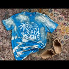 Brand New Bleached Tee Bleaching Could Differ Casual Blue T-shirt For Beach Party, Acid Wash Summer Vacation Tops, Acid Wash Tops For Summer Vacation, Blue Relaxed Fit Top For Vacation, Tie Dye Crew Neck Top For Beach, Light Blue Summer Vacation T-shirt, Blue Distressed T-shirt For Summer, Acid Wash Top For Beach In Spring, Acid Wash Tops For Beach In Spring