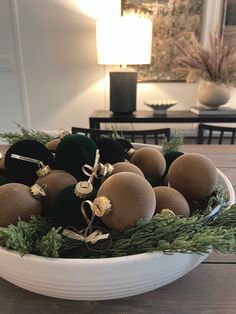 a bowl filled with ornaments on top of a wooden table