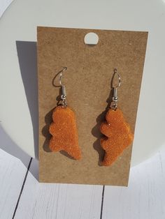 You'll feel like a kid again with these Dino chicken nuggets! You just need the ketchup! Dino Nugget Earrings, Weird Earrings Aesthetic, Dino Nuggies, Dino Chicken Nuggets, Silly Earrings, Dino Nuggets, Dino Earrings, Weird Earrings, Crazy Earrings