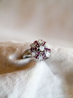 White Gold Cluster Diamond Ring With Multi-stone, Heirloom White Cluster Ring, Classic Ruby Cluster Ring, Vintage Ruby Cluster Ring With Center Stone, Classic Ruby Cluster Ring With Center Stone, Classic Cluster Ruby Ring With Center Stone, White Gold Cluster Ruby Ring, Vintage Multi-stone Diamond White Rings, Vintage Multi-stone Diamond Rings