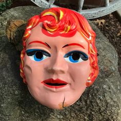 "This vintage Halloween mask is a red-headed woman or girl. It was manufactured in the 1950's. The mask measures 6.5\" w x 8\" h. A fun mask to add to your collection! Great for display! The mask is in fair condition: numerous splits especially in the chin area; tape residue; some soil; elastic band is present but frayed. Otherwise, no missing parts. Satisfaction guaranteed. NOTE: we have put a piece of tape on the back side to stabilize the chin area so no more damage will occur during shipping Vintage Masks For Halloween Costume Party, Vintage Halloween Masks And Prosthetics For Costume Party, Vintage Halloween Costume Masks And Prosthetics, Vintage Halloween Costume Party Masks, Vintage Masks For Carnival Costume Party, Vintage Masks For Costume Party, Vintage Carnival Mask And Prosthetics, Vintage Halloween Carnival Masks And Prosthetics, Vintage Halloween Mask