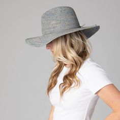 Be ready for any outdoor occasion in style with the Marina Women's Crochet Raffia Fedora. This exquisite fedora is crafted with 100% Crochet Raffia and features a 4" brim and adjustable size to fit perfectly. Choose between a brown, blue, or natural hue with the unique addition of twisted cording and bow in the center back. Elevate your ensemble and be the talk of the town in this one of a kind fedora. Features: Colors: Brown, Blue, & NaturalMaterials: 100% Crochet RaffiaBrim Size: 4" BrimSize: Blue Fedora Panama Hat For Kentucky Derby, Blue Western Straw Hat With Curved Brim, Western Blue Wide Brim Sun Hat, Blue Curved Brim Sun Hat For Rodeo, Blue Brimmed Straw Hat For Rodeo, Wide Brim Blue Sun Hat For Rodeo, Blue Curved Brim Sun Hat For Country Events, Bohemian Blue Fedora For Spring, Fitted Crochet Hat For Spring