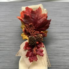 a pair of flip flops decorated with fall leaves and pineconis are sitting on a table