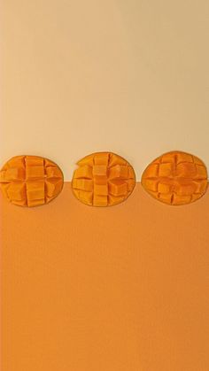 three pieces of bread sitting on top of each other in the middle of an orange background