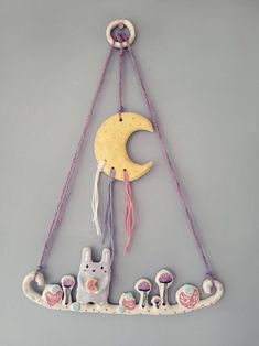 a wall hanging with an animal and moon decoration