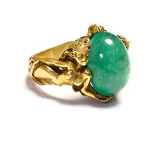 Antique Gold Large Cabochon Emerald Nude Lady Ring Dive into the enchanting realm of Art Nouveau with this magnificent gold ring, a testament to exquisite craftsmanship and artistic vision. This piece features a delicate assembly of sculpted ladies, each figure intertwined gracefully, representing the period's fascination with fluid, natural forms. At the center of this collective beauty sits a striking cabochon emerald, its lush green depths echoing the vibrant life of untouched nature. This si Luxury Gold Emerald Collectible Ring, Luxury Gold Emerald Ring Collectible, Collectible Yellow Gold Emerald Cabochon Ring, Collectible Yellow Gold Emerald Ring With Cabochon, Art Nouveau Yellow Gold Intaglio Jewelry, Gold Art Nouveau Jewelry With Intaglio, Luxury Cabochon Emerald Ring Gift, Luxury Cabochon Emerald Ring As Gift, Art Nouveau Gemstone Ring Jewelry