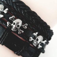 Whether you are into riding, playing your guitar or just hanging out and relaxing, this skull leather bracelet set will go well with any of your outfit. This bracelet set comes with 3 separate bracelets. You can wear them as a set or individually to create a different look every time. The set consists of metal skulls, beads, leather and studs. Product Information Bracelet set comes with 3 separate bracelets Material: leather/faux leather Chain Type: rope chain Length: adjustable 7 - 8.5 inches M Black Gothic Leather Bracelet With Skull Shape, Gothic Black Leather Bracelet With Skull, Black Gothic Leather Bracelet With Skull, Black Gothic Leather Skull Bracelet, Gothic Black Leather Skull Bracelet, Black Rocker Bracelets For Festivals, Black Rocker Style Leather Bracelet For Festivals, Punk Silver Leather Skull Bracelet, Silver Skull Leather Bracelet In Punk Style