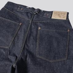 Introducing our raw, loose, 1910s model, selvedge jeans from the 2023 Autumn Collection a classic established textured to add a touch of vintage charm to your wardrobe!Why You'll Fall In LoveThese jeans are the perfect blend of vintage and modern style, boasting a unique and quintessential self-edge look. From its midweight 13oz fabric to its tall-waisted buttoned waistline, you can be sure that these jeans will keep you looking effortlessly chic.Distinctive Features: Selvedge Style: With a agel Classic Dark Wash Pre-washed Bottoms, Classic Selvedge Denim Bottoms, Classic Selvedge Dark Wash Bottoms, Classic Indigo Bottoms For Streetwear, Classic Wide Leg Selvedge Bottoms, Indigo Selvedge Rigid Denim Bottoms, Classic Selvedge Wide Leg Bottoms, Classic Pre-washed Denim Blue Jeans, Indigo Selvedge Bottoms For Streetwear