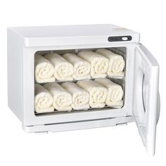 a white microwave oven filled with lots of rolled up towels in it's door