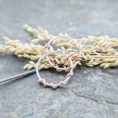 I carefully handform these pretty little hoops out of 22 gauge (0.64mm) wire, file the ends smooth and wrap them randomly in your choice of gold fill, sterling silver, niobium, brass and copper. These are small and delicate looking. I wear them in my 3rd holes. Shown: niobium and rose gold fill, 6mm id sterling silver and gold fill, 8mm id sterling silver and niobium,10mm id The final shot shows the 28g 14k white, 26g 14k yellow, 24g 14k pink, 22g niobium and 20g sterling silver so that you can Dainty Small Hoop Earrings With Wire Wrapped Detail, Dainty Handmade Small Hoop Cartilage Earrings, Handmade Bronze Hoop Jewelry, Vintage Bronze Hoop Earrings With Ear Wire, Bohemian Bronze Wire Wrapped Hoop Earrings, Nickel-free Small Hoop Copper Jewelry, Nickel-free Gold Hoop Earrings With Copper Wire, Jewelry Earrings Hoops, Vines