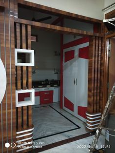 a kitchen with red and white accents in the middle of it's flooring