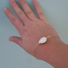 Description This white bangle features a smooth white glass teardrop in a brass setting. This bangle is great to add to any arm party collection. Request a Custom Order Join more than 89 thousand delighted customers! - - - - - - - - - - - - - - - Sizing Pick from the easy size chart below or measure circumference of widest part of hand while reaching thumb toward pinkie to make hand narrow. Measure in this position since bangle slides over hand. All of my bangles are clasp-free, slide on over th Snow White Jewelry, Vintage Snow White, White Bracelet, Brass Band, Stone Bangle, Arm Party, White Bracelets, Stacked Bangles, White Jewelry