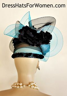 Ladies  Turquoise Blue And Black Custom Made Couture Big Bow Kentucky Derby Hat For The Spring Races. This Dramatic Lift Up Wide Scalloped Brim Hat Is Constructed In Horsehair Or Crinoline. This Stylish Church Hat Is Embellished With Handmade Vintage Black Flowers Containing Black Sequin Flowers Placed In The Center Of Each Handmade Flower.  A Row Of Beautiful Organza And Sequin Trim Adorned With Organza Roses And Leaves Encircles The Base Of This Haute Couture Dress Hat. This Elegant Fitted Blue Mini Hats For Church, Blue Costume Hats And Headpieces For Church, Blue Fitted Mini Hat For Church, Fitted Blue Mini Hat For Races, Luxury Blue Headpieces For Kentucky Derby, Fitted Turquoise Hat For Party, Turquoise Fitted Hat For Party, Turquoise Fascinator For Kentucky Derby, Turquoise Fitted Party Hat