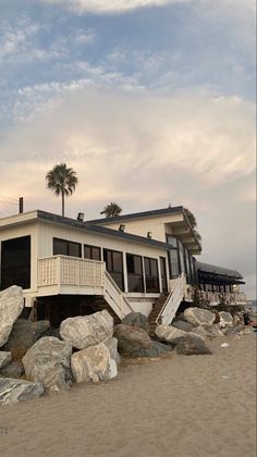 a house sitting on top of a pile of rocks