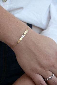 "This bracelet is the is the perfect heirloom piece. A bar charm is laser engraved with your handwriting for the perfect keepsake. Bar charm is stainless steel and plated in 18K gold. Bracelet requires little to no maintenance because stainless steel does not tarnish. Back of bracelet has three loops for attachment at 6\", 6.5\" and 7\". Details * Material - stainless steel * Bar measures 4mm by 35mm * total bracelet length is 7\" with clasp at 6\", 6.5\" and 7\" for the perfect fit. After you c Engraved Name Bracelet For Friendship, Minimalist Engraved Name Bracelet For Friendship, Minimalist Engraved Charm Bracelet For Friendship, Everyday Engraved Name Bracelet In Rectangular Shape, Engraved Nameplate Bracelet For Friendship, Gold Stamped Bracelet For Everyday, Meaningful Everyday Jewelry With Engraving Option, Everyday Nameplate Jewelry With Engraving Option, Everyday Hand Stamped Name Bracelet