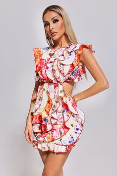 The Unyque Cutout Flounced Printed Mini Dress is a delightful blend of fashion-forward design and playful elegance. With its eye-catching print and flirty flounced hem, it's a celebration of individual style. The strategically placed cutouts add an alluring touch while maintaining a sense of chic sophistication. Pair the Unyque Cutout Flounced Printed Mini Dress with strappy sandals, espadrilles, or ankle boots for a relaxed and stylish look.  Fabric composition: 95% polyester, 5% spandex  Washing method: gently hand wash or dry clean or machine wash   Model wearing size S  Model Stats:Height - 68.5"/174cm Bust - 35"/89cm Hips -37.4"/95cm Waist- 25.2"/64cm  Colour may vary due to lighting on images.  Item runs true to the size chart and is cut to suit our size chart. Please refer to our si Flirty Ruffled Floral Party Dress, Flirty Ruffle Hem Mini Dress For Garden Party, Flirty Mini Dress With Ruffle Hem For Garden Party, Multicolor Ruffled Mini Dress For Brunch, Multicolor Ruffles Mini Dress For Brunch, Flirty Printed Mini Dress, Sleeveless Printed Floral Party Dress, Flirty Summer Ruffle Dress For Garden Party, Summer Party Multicolor Floral Dress