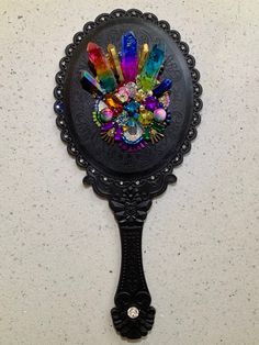 a black mirror with colorful jewels on it