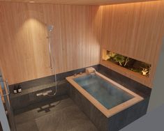 a bathroom with a large jacuzzi tub next to a walk in shower and wooden walls