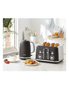 two toasters sitting on top of a counter next to a plate with food in it