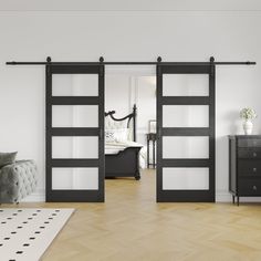 an empty room with black and white sliding doors