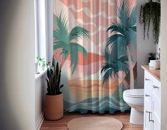 a bathroom with a palm tree shower curtain