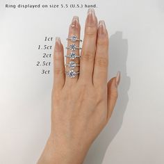 a woman's hand with five diamond rings on her left and right index finger