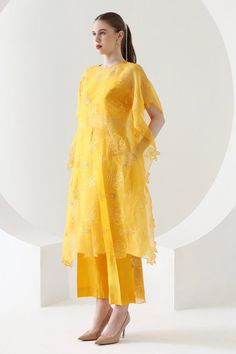 Canary yellow three fourth sleeves kaftan in organza base with all over blossom thread work and pearls embellishments. Paired with matching straight pant. 
Components: 2
Pattern: Embroidery
Type Of Work: Thread Work, Pearls
Neckline: Round 
Sleeve Type: Three Fourth
Fabric: Organza
Color: Yellow
Other Details: 
Asymmteric hem kaftan
Floral cut work hem kaftan
Model height: 5ft 8inches
Length:
Kaftan: 42 inches
Pant: 40 inches
Occasion: Sangeet, Mehendi and Haldi - Aza Fashions Yellow Embroidered Organza Set, Yellow Short Sleeve Party Set, Yellow Organza Kurta For Festivals, Summer Organza Palazzo Set With Sheer Dupatta, Yellow Organza Dress With Resham Embroidery, Yellow Organza Kurta For Festive Occasions, Yellow Silk Dress With Chikankari Embroidery, Yellow Tissue Silk Dress For Festivals, Yellow Kaftan For Wedding And Festivals