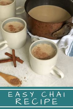 three mugs of chai with cinnamon on the side