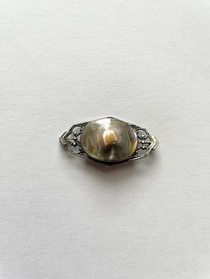 This is a beautiful vintage antique Victorian sterling silver blister pearl pin brooch. The pin is hallmarked Sterling on the reverse and has a classic Victorian C clasp.  It measures 1 3/8" x 3/4"  The blister pearl measures 16mm x 21mm This item is in excellent preowned vintage condition it has withstood the test of time Vintage White Gold Oval Brooches, Elegant Silver Brooch With Screw Back, Formal Silver Heirloom Brooch, Formal Silver Brooches With Screw Back, Formal Silver Brooch With Screw Back, Vintage Silver Lapel Pin For Anniversary, Classic Oval Silver Brooches, Vintage Silver Anniversary Lapel Pin, Silver Vintage Anniversary Lapel Pin