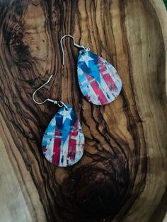 pair of american flag tear earrings on wooden background