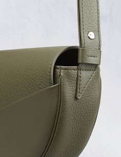 Khaki smooth calfskin and bullcalf leather Designer Soft Leather Crossbody Shoulder Bag, Designer Leather Crossbody Bag, Designer Soft Leather Crossbody Bag, Textured Leather Saddle Shoulder Bag For Travel, Luxury Textured Leather Saddle Bag, Modern Textured Leather Crossbody Satchel, Luxury Saddle Bag With Leather Lining For Daily Use, Smooth Grain Crossbody Office Bag, Designer Flap Shoulder Bag With Leather Lining