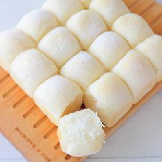 a cutting board that has some kind of food on top of it and is cut into cubes