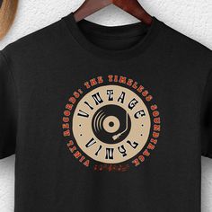 "Introducing our \"Groove Enthusiast\" Vinyl Records Lover T-Shirt: 🎵 Custom Vinyl Record Shirt: Personalize your passion for vinyl records. 🪀 Vintage Vibes: Embrace the timeless allure of vinyl records. 🎁 Perfect Gift: An ideal present for any vinyl records enthusiast. 🎶 Music Magic: Let your shirt speak volumes about your love for music. 🕺 Groove in Style: Wear your vinyl records passion with pride. 🎤 Retro-Chic: Rock a classic look with this vinyl record tee. 🧡 Vinyl Records Lover: Dec Beer Branding Design, Custom Vinyl Record, Lover Vinyl, Music Magic, Records Vinyl, Vinyl Record Art, Vinyl Collectors, Vinyl Collection, Rock A