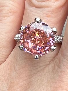 A Rare 6.84CT Round Brilliant Cut VVS1 Fancy Padparadscha Pink Moissanite Solitaire Engagement Ring Size 6.75. Our fancy colors, like this padparadscha pink are created through a special heating process with ion induction. This color is completely permanent and will not fade or change in any way.   🔥 MOST POPULAR COLOR FOR 2023!  Shape & Cut: Round Brilliant Measurements: 12mm  Diamond Weight:6.84CT Color Grade : Fancy Padparadscha Sapphire Pink Clarity: VVS1 Polish: Excellent Symmetry: Excellent Fluorescence: None 🪛Size 6 ships in 1-2 days 💨RUSH SHIPPING SERVICE AVAILABLE, MESSAGE ME! Padparadscha Sapphire Engagement Ring, Fancy Pink Diamond Ring, Cartier Wedding Rings, Pink Diamond Ring, Padparadscha Sapphire, Moissanite Engagement Ring Solitaire, Engagement Ring Sizes, Pink Diamond, Gold Jewelry Fashion