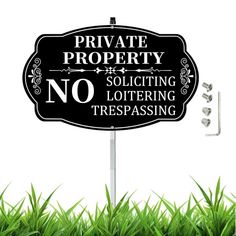 a black and white sign that says private property no solicing loitering trespassing