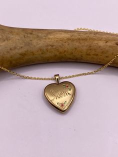 "Vintage tiny mini heart locket  9k Gold filled Engraved with \"Mom\" This tiny treasure has about a half inch photo space, just the locket without the bale.  Vintage 1960's one of a kind.  Does not tarnish or change color.  on a gold 925 chain 16, 18, 20 or 24 inch  Lovely etched design Can hold tiny sized photo. Laminate photo before inserting for longevity  Ships on a gold 925 sterling silver chain  Thank you for supporting a small veteran owned business! All jewelry is shipped free within th Dainty Rose Gold Locket Necklace For Anniversary, Rose Gold Hallmarked Locket Necklace Gift, Mother's Day Heart Charm Locket Necklace Gift For Mom, Dainty Pendant Locket Necklace For Mother's Day, Gold Locket Necklace With Hallmark For Mother's Day, Vintage Open Heart Jewelry For Mother's Day, Dainty 14k Gold Locket Necklace Gift, Gold Locket Necklace For Mother's Day With Hallmark, Gold Locket Necklace For Mother's Day