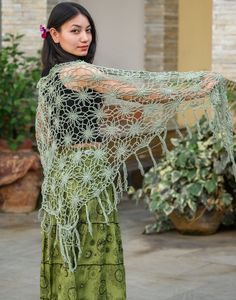 Embrace the magic of nature with the Floral Web Wrap Shawl; a hand-crocheted masterpiece adorned with intricate floral patterns and whimsical fringe, in a gorgeous seafoam green. This generously sized triangle shawl offers the perfect blend of style and comfort, effortlessly elevating your look, whether you're dancing under festival lights or savoring a cool evening outdoors. Crafted from soft, lightweight yarn, it drapes beautifully over your shoulders, providing cozy warmth without sacrificing Green Shawl For Beach In Spring, Green Shawl For Beach, Green Shawl For Spring Beach Outings, Green Shawl For Spring Beach Occasions, Spring Green Shawl For Beach, Spring Festival Crochet Shawl, Bohemian Hand Knitted Lace Shawl, Crochet Shawl For Spring Festival, Handmade Bohemian Shawl For Spring