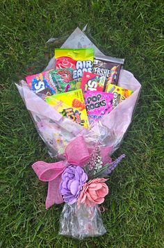 a bouquet of candy and flowers on the grass