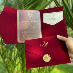 a person holding two red envelopes with gold foil on the front and back, both open