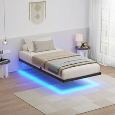 a bed that has some lights on the side of it and is in a room with wood flooring