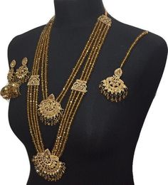 Mala jewellery set. Set includes- Mala Necklace  Earrings  Tikka Yellow Gold Kundan Temple Jewelry, Gold Kundan Chandbali Necklace With Stone Work, Gold Jewelry With Zari Work For Gifts, 22k Gold Meenakari Bridal Necklace For Wedding, Ceremonial Gold Jewelry With Zari Work, Elegant Gold Sets With Stone Work, Kundan Yellow Gold Jewelry For Diwali, Bollywood Necklaces With Latkans For Wedding, Gold Plated Gold Jewelry With Meenakari