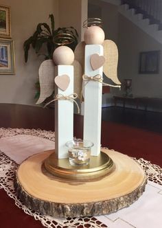 two candles are sitting on top of a wooden stand in front of a mirror with hearts