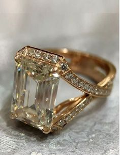 a fancy ring with an emerald cut diamond