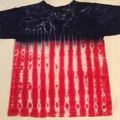 Tie dye Large kids crew neck Tshirt.  The shirt pictured is the one you will receive.  It is a Faded Glory brand crew neck Large children's or pre- teen shirt size 14-16. Made with a deep royal blue and red for the colors of our American flag.  It was tied so that you get the shots of white throughout the blue.   Faded Glory can run a bit smaller then some of the other manufacturers so check out the measurements.  It is a very good quality 100% cotton knit shirt.  It measures 21 1/2 inches from the tip of the crew neck at the shoulder to the hem and 17 inches across or 34 inches around. If you would like this in another size, leave me a message and I can private message you a picture of the one you will get before you buy it.  It will look very much like the one pictured here. Smaller chil Patriotic American Flag Print T-shirt For Summer, Multicolor American Flag Tops For Summer, Casual Multicolor T-shirt For 4th Of July, Blue T-shirt With American Flag, Patriotic Multicolor Tops For Independence Day, Blue Patriotic T-shirt With American Flag Print, Blue American Flag T-shirt, Multicolor Cotton T-shirt For 4th Of July, American Style Blue T-shirt With American Flag